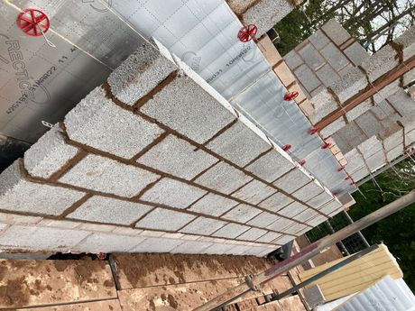Cavity blockwork walls built with a mixer and tools next to it.