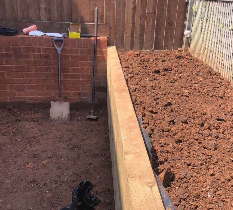 Dyl Garden Wall Build garden wall built by Dyl for Devon Expert Bricklayers in a muddy garden with tools out