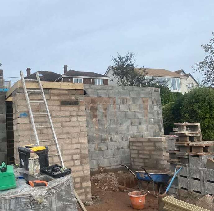 Dyl Block Work Block Work job completed with load bearing wall and a ladder stood up with tools and wheel barrow on the floor