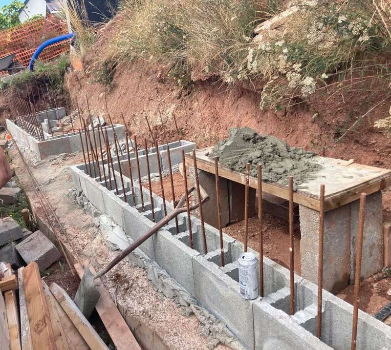 block wall build with reinforced bars for strength outside with bush