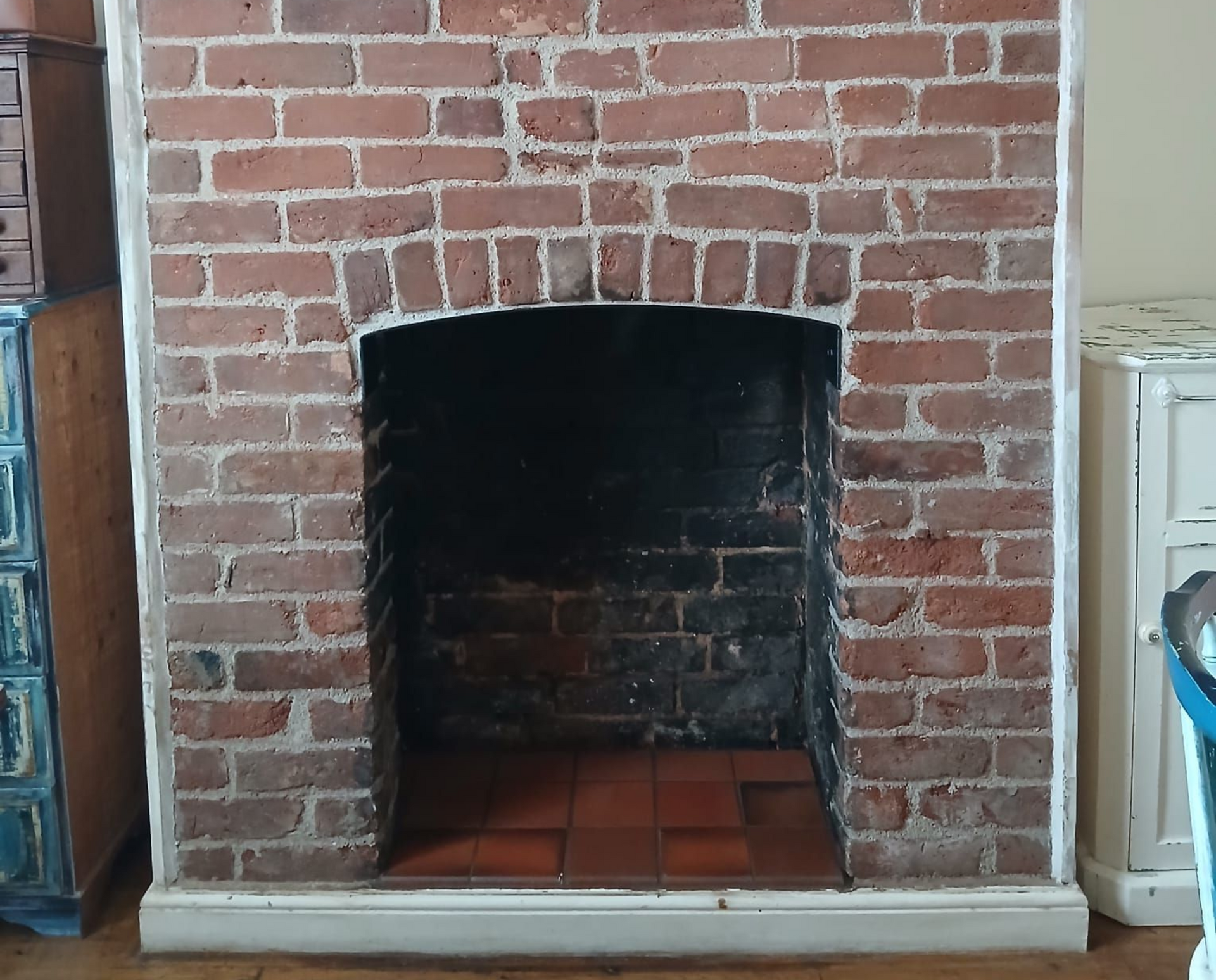 Recent work in Exeter Brick retaining wall with flower bed and patterned tile flooring.