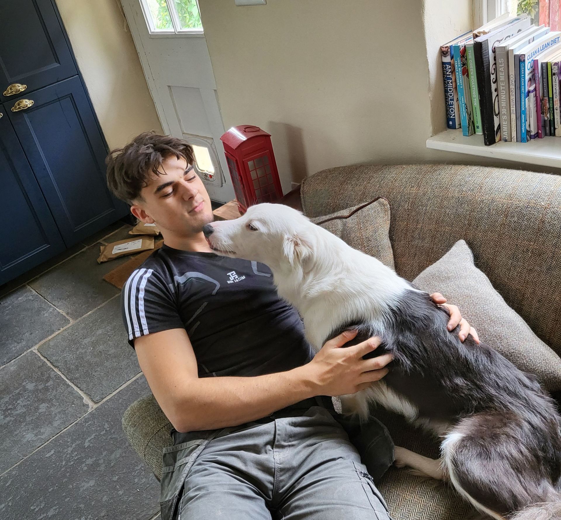 Jack Frame Co-Founder with his dog on sofa. Devon Expert Builders & Home Improvements 