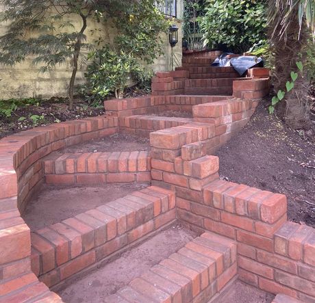 a new set of brick steps made from fresh bricks in a sunny garden in a close up picture
