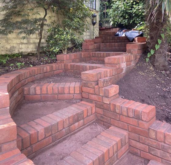 a new set of brick steps made from fresh bricks in a sunny garden in a close up picture