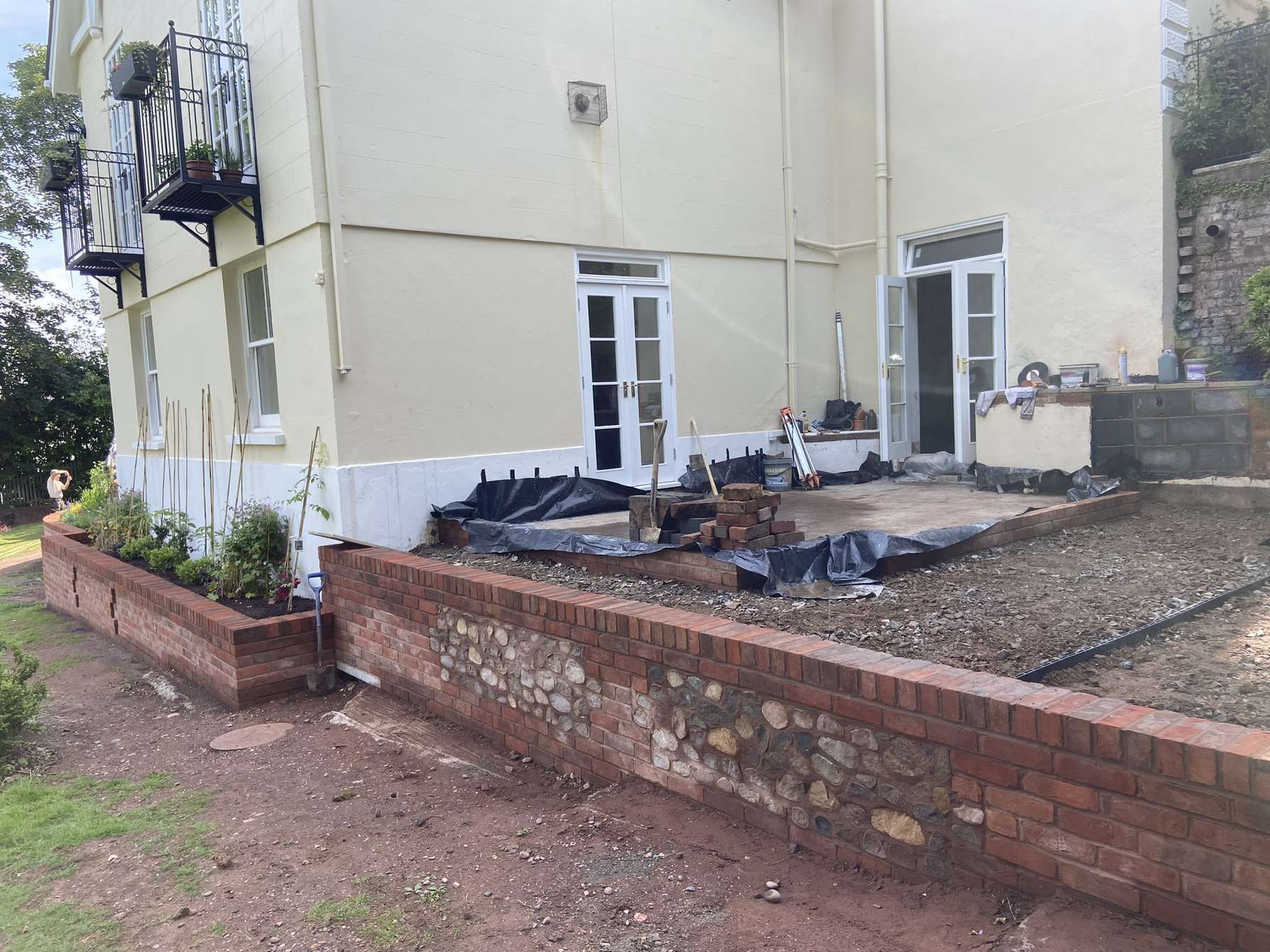 Brad re-point A picture of a retaining brick wall out the back of a house in the shade