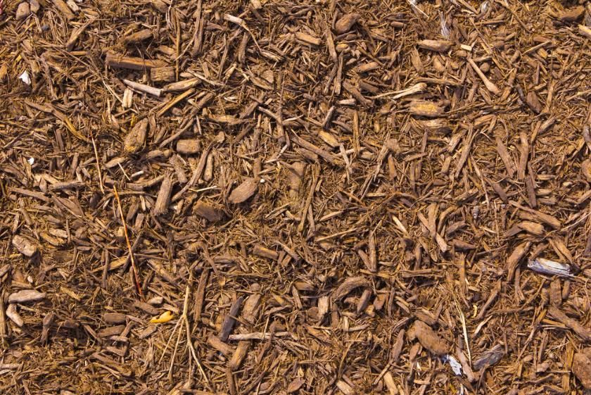 A Pile of Brown Mulch Is Sitting on The Ground — All One Arb Tree Service In Bonny Hills, NSW