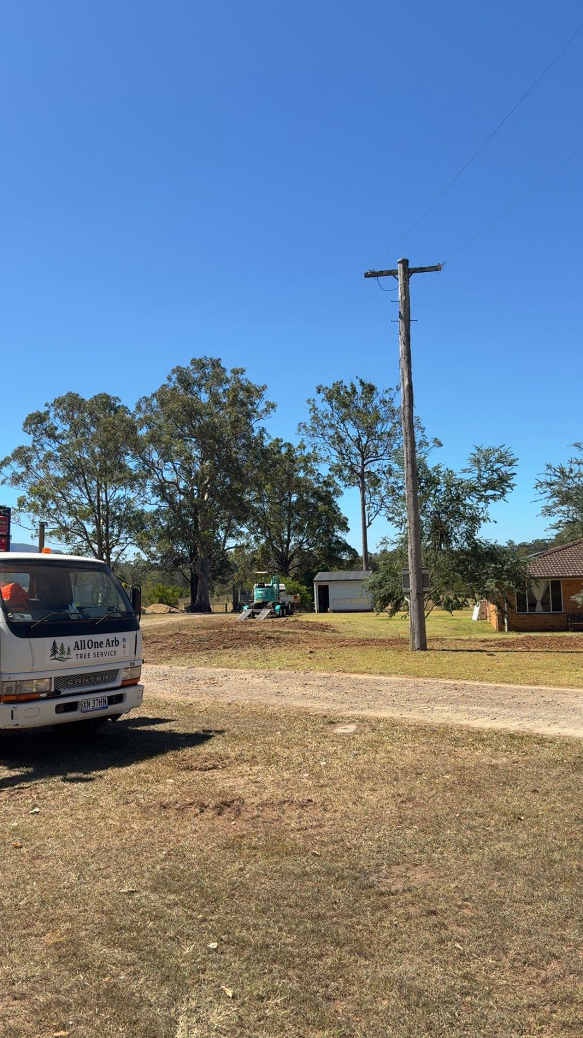 Truck Parked on Dirt Road Near Power Pole and Trees — All One Arb Tree Service In Port Macquarie, NSW