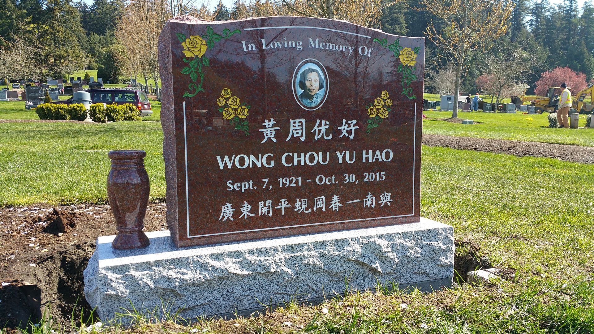a gravestone for wong chou yu hao is in a cemetery .
