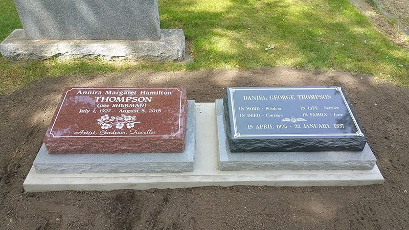 Two graves are sitting next to each other in a cemetery.