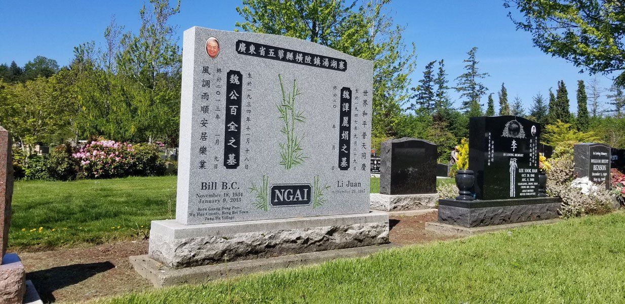 a cemetery with a large stone monument in the middle of it .
