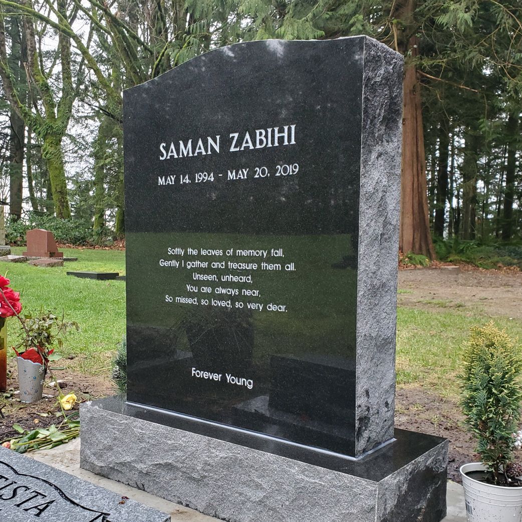 a black gravestone with the name saman zabihi on it