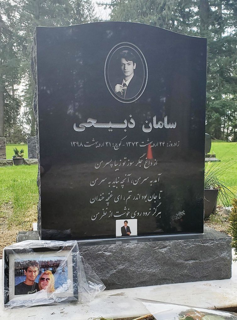 a black gravestone with a picture of a man on it