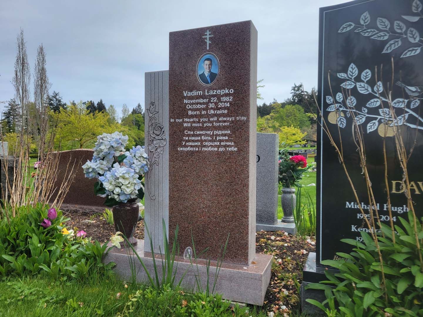 a gravestone in a cemetery with a picture of a man on it