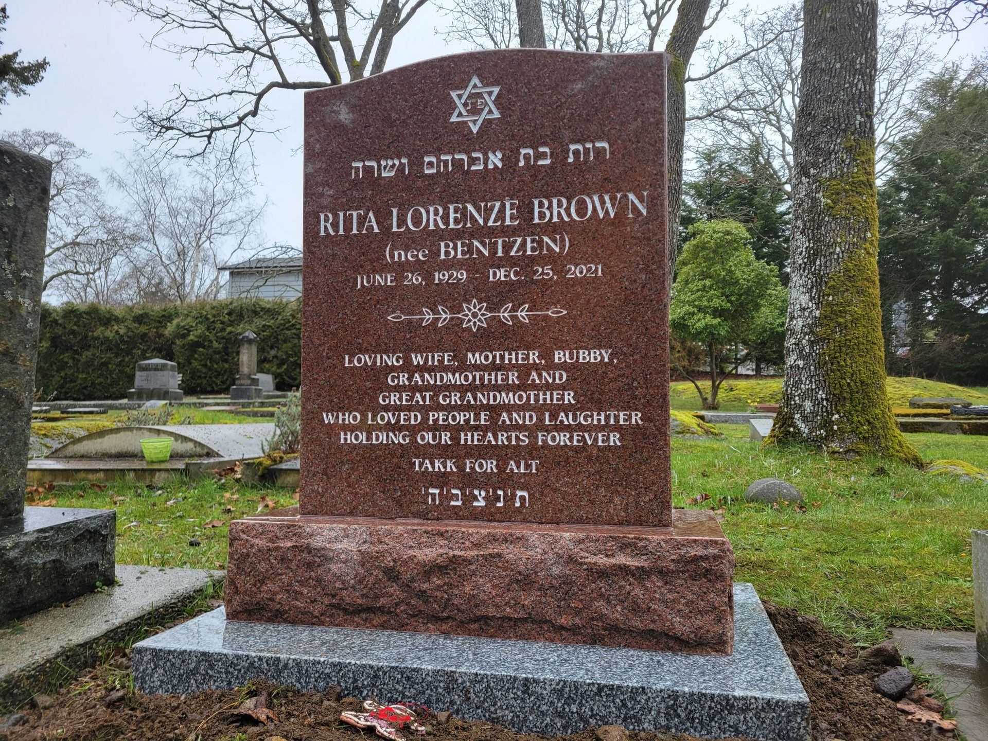 a gravestone in a cemetery with a star on it .