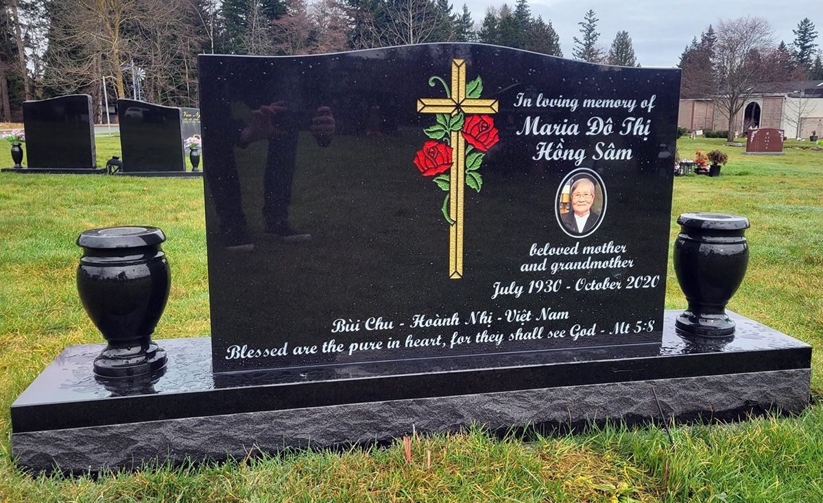 24x36 ebony black granite upright with photo plaque, coloured paint and 2 vases. Ebony black base with 2inch polished top margin.