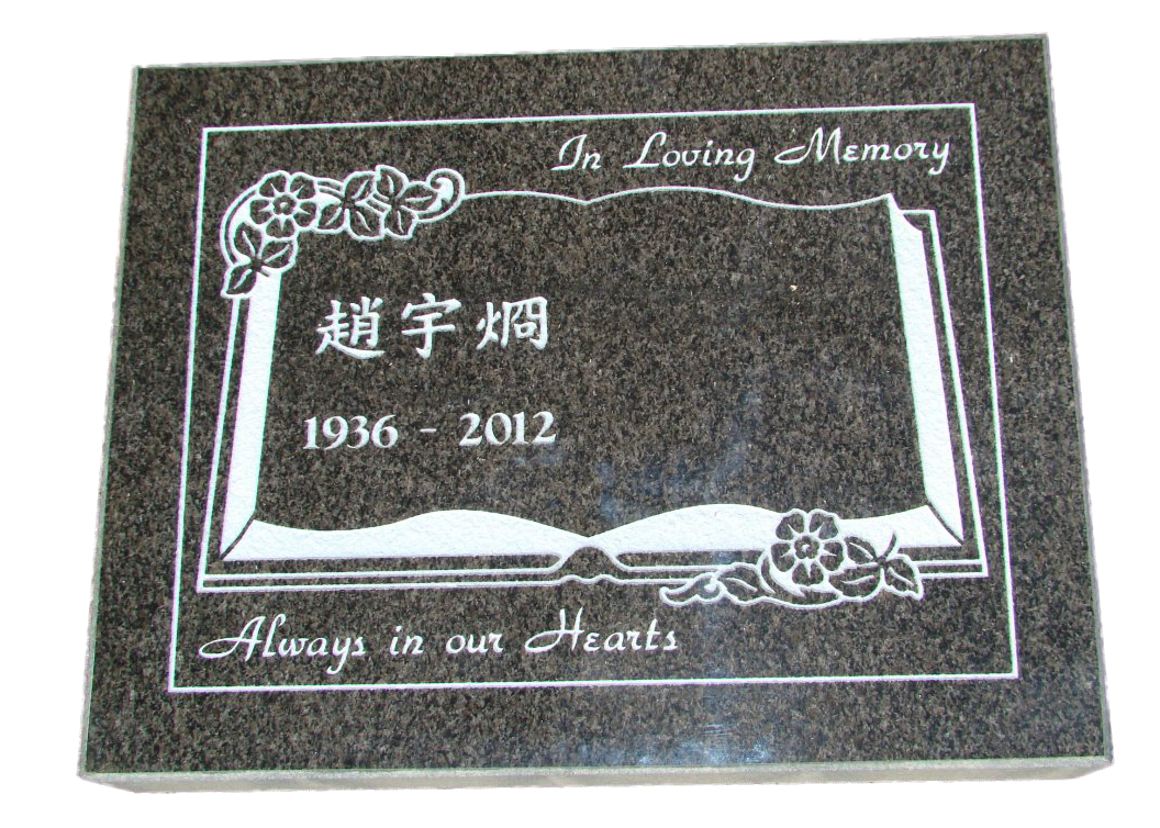 a gravestone with a picture of an open book and flowers on it .