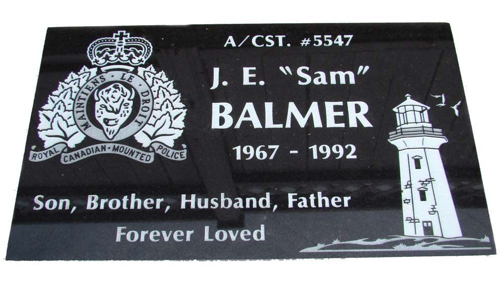 A gravestone for j. e. balmer with a lighthouse on it