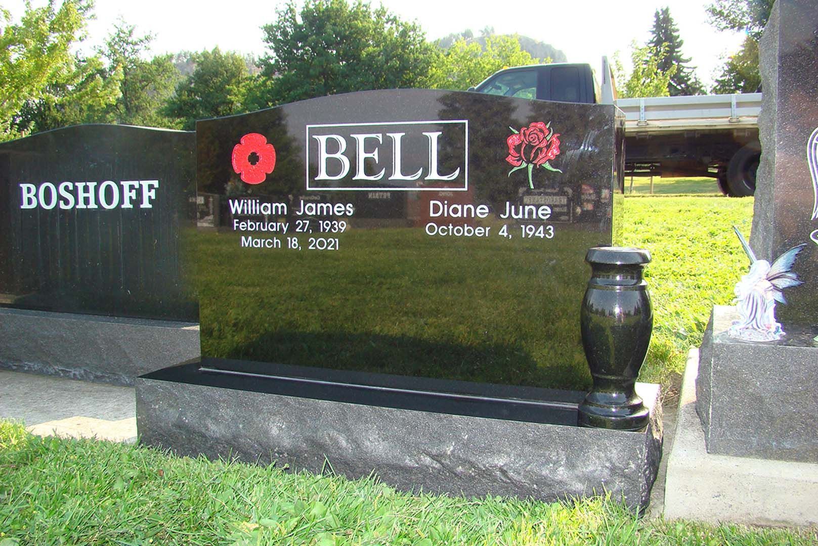 a black gravestone with the name bell on it