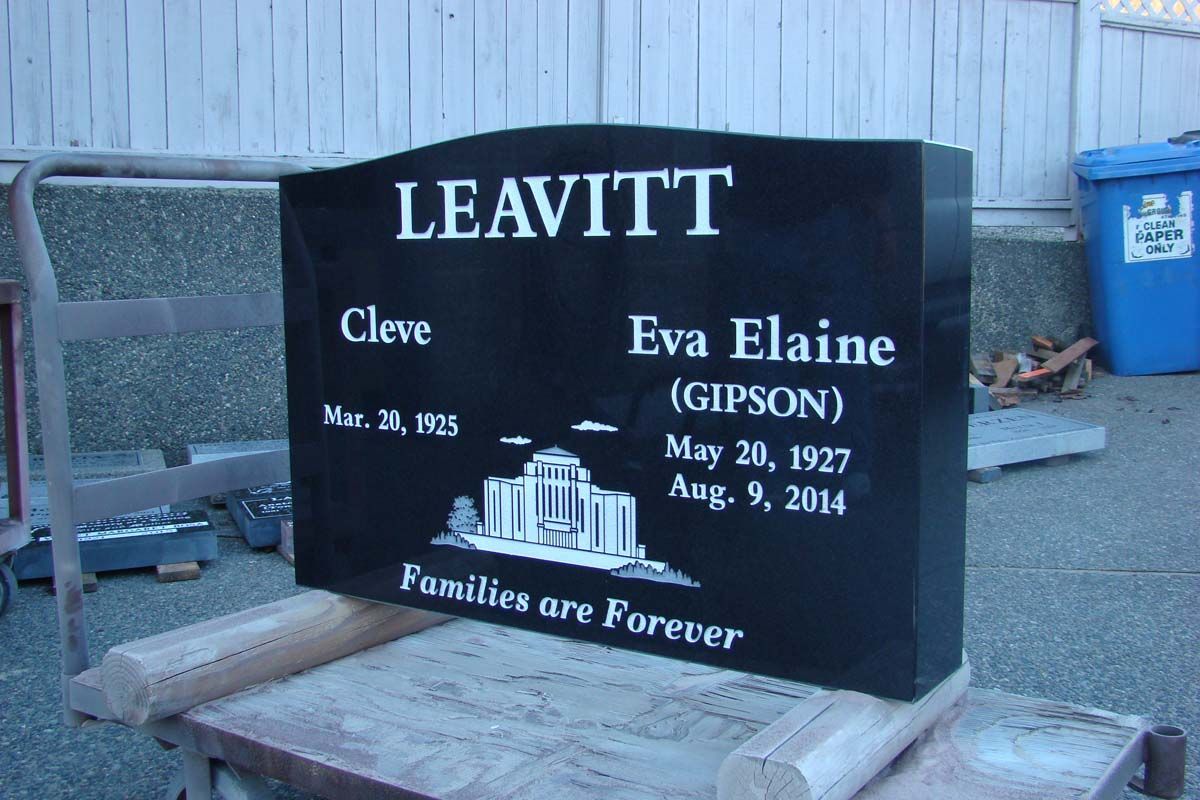 a black gravestone for leavitt and eva elaine