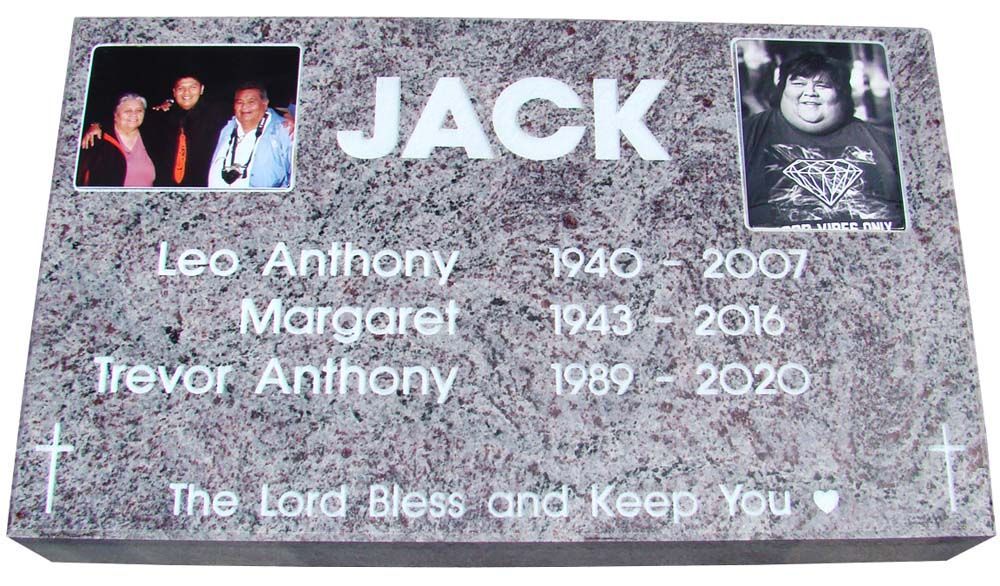 A gravestone for jack with a picture of him on it