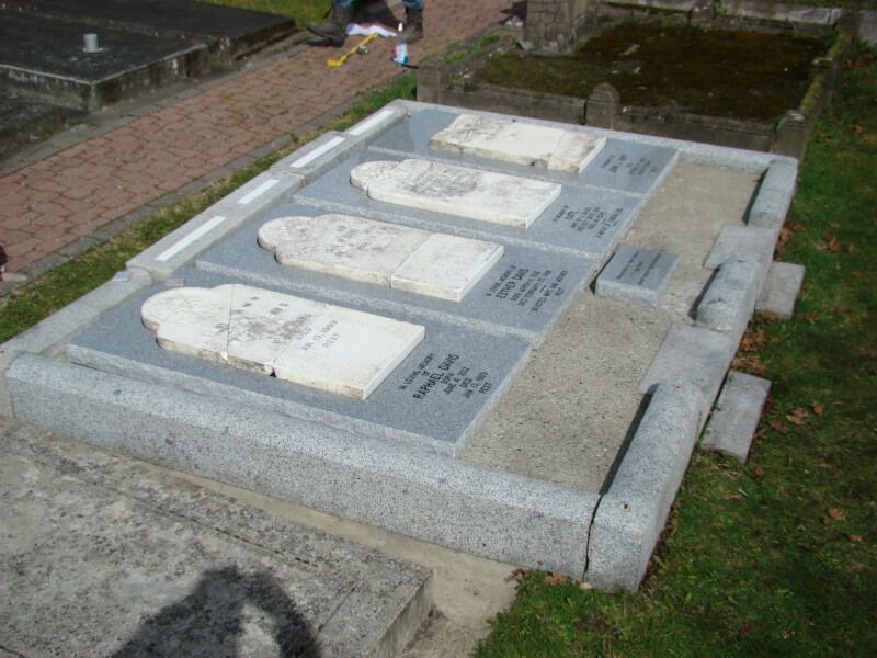 a row of graves in a cemetery with chinese writing on them