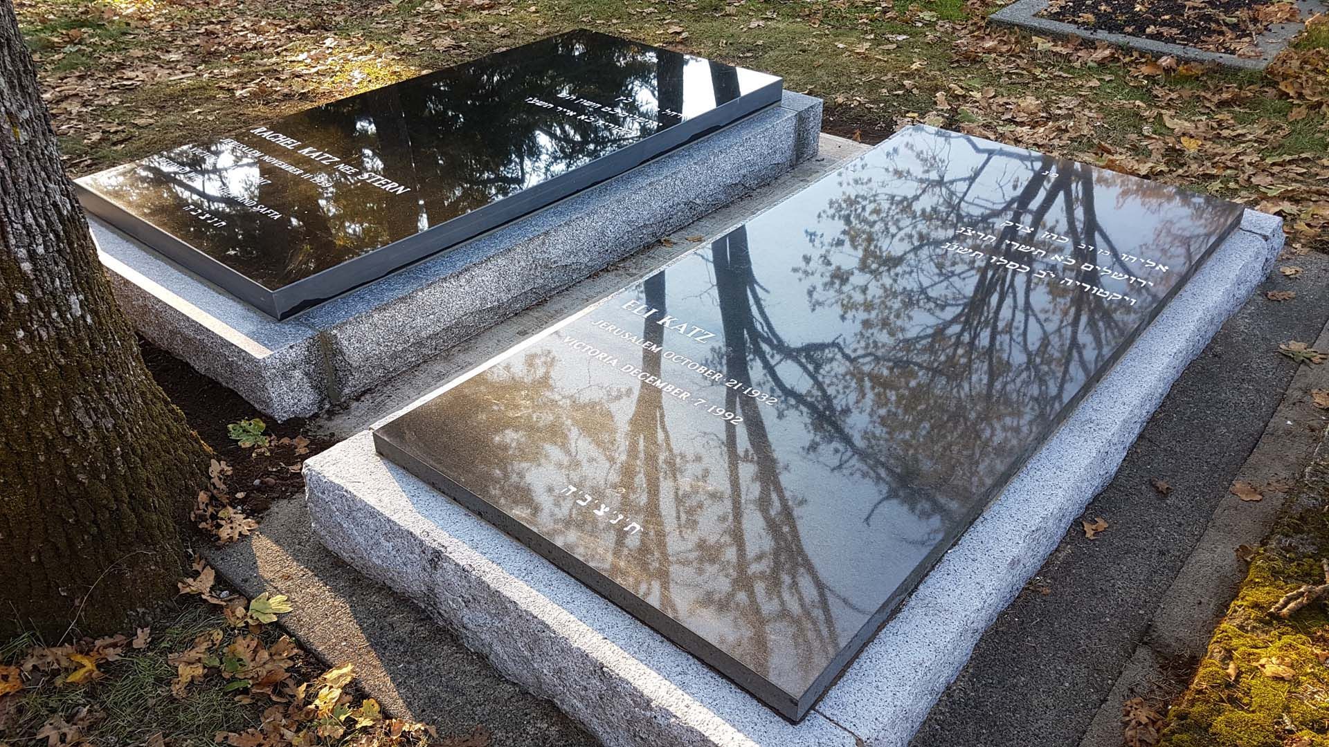 two graves are sitting next to each other in a cemetery .
