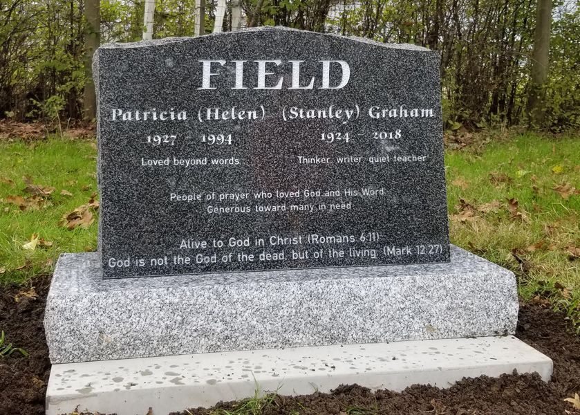a gravestone for patricia field in a cemetery with trees in the background .