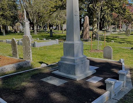A cemetery with a large obelisk in the middle of it.
