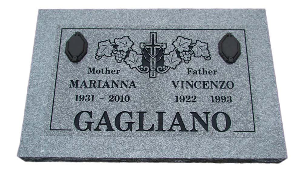 A gravestone for a man named gagliano with a cross and grapes on it.