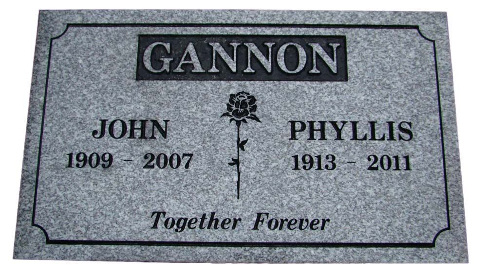 A gravestone for john and phyllis with a rose on it