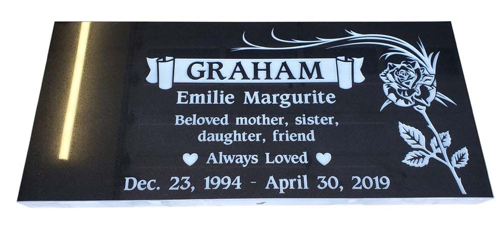 A gravestone for emilie marguerite graham with a rose on it