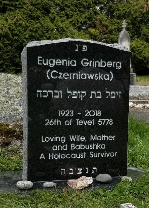 a gravestone for eugenia grinberg in a cemetery