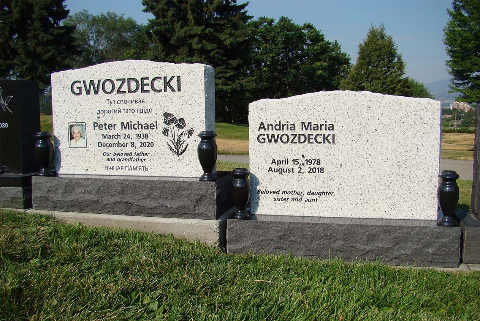 two graves in a cemetery one of which says gwozdecki