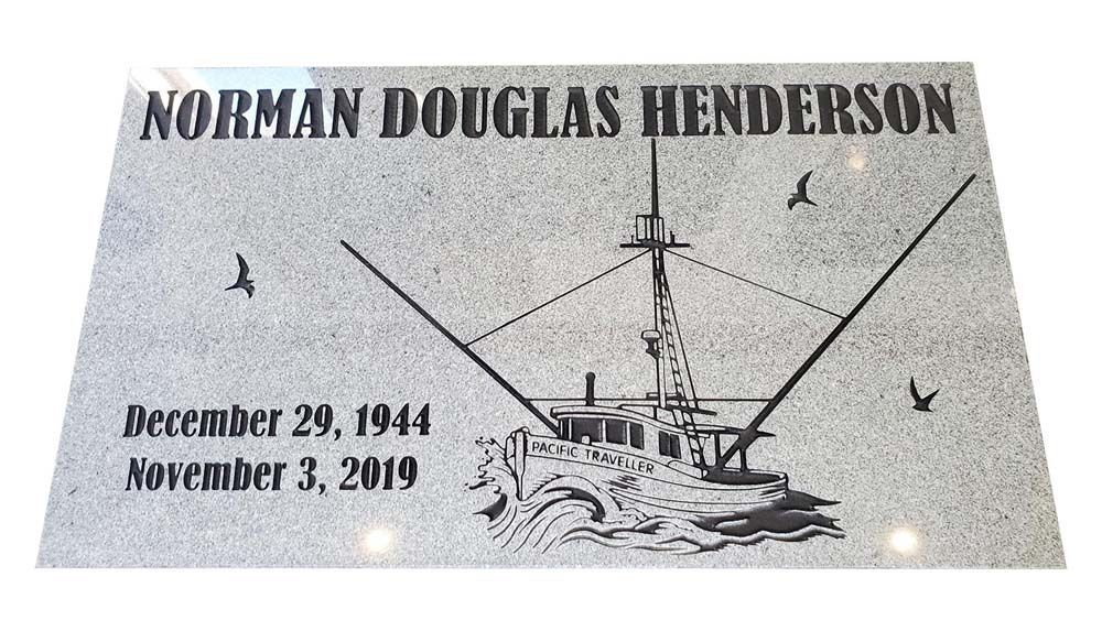 a gravestone for norman douglas henderson with a boat on it
