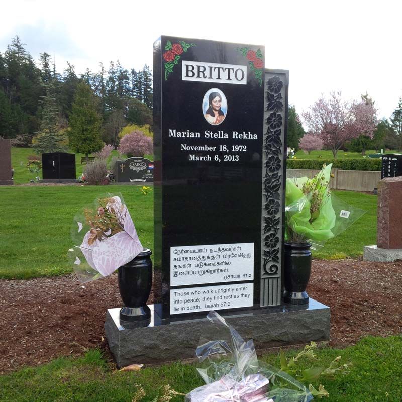 a black granite gravestone for britto in a cemetery