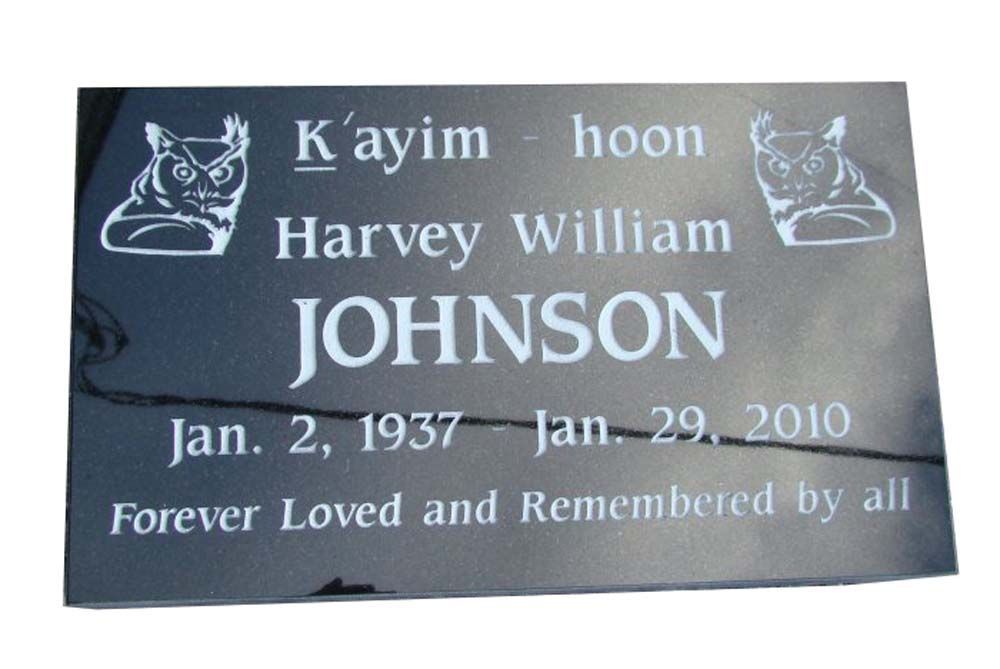 A black plaque with the name harvey william johnson on it