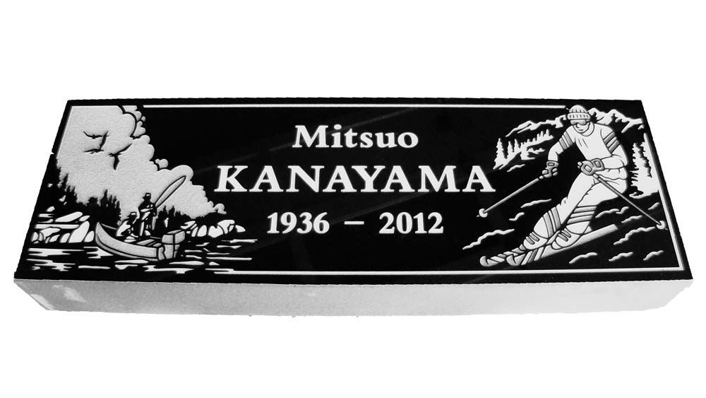 A black and white grave marker for mitsuo kanayama