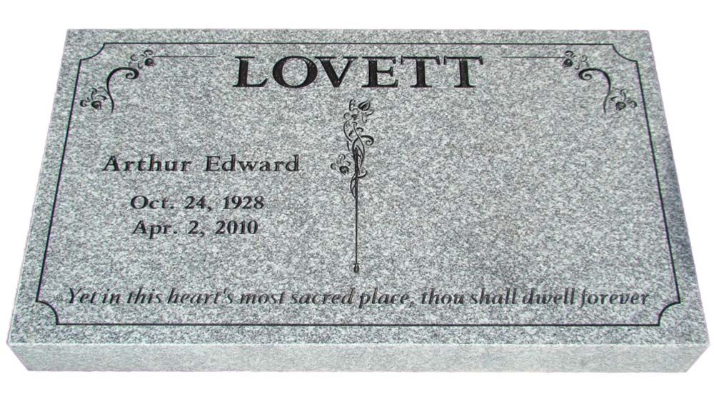 A gravestone for arthur edward lovett with a cross on it.