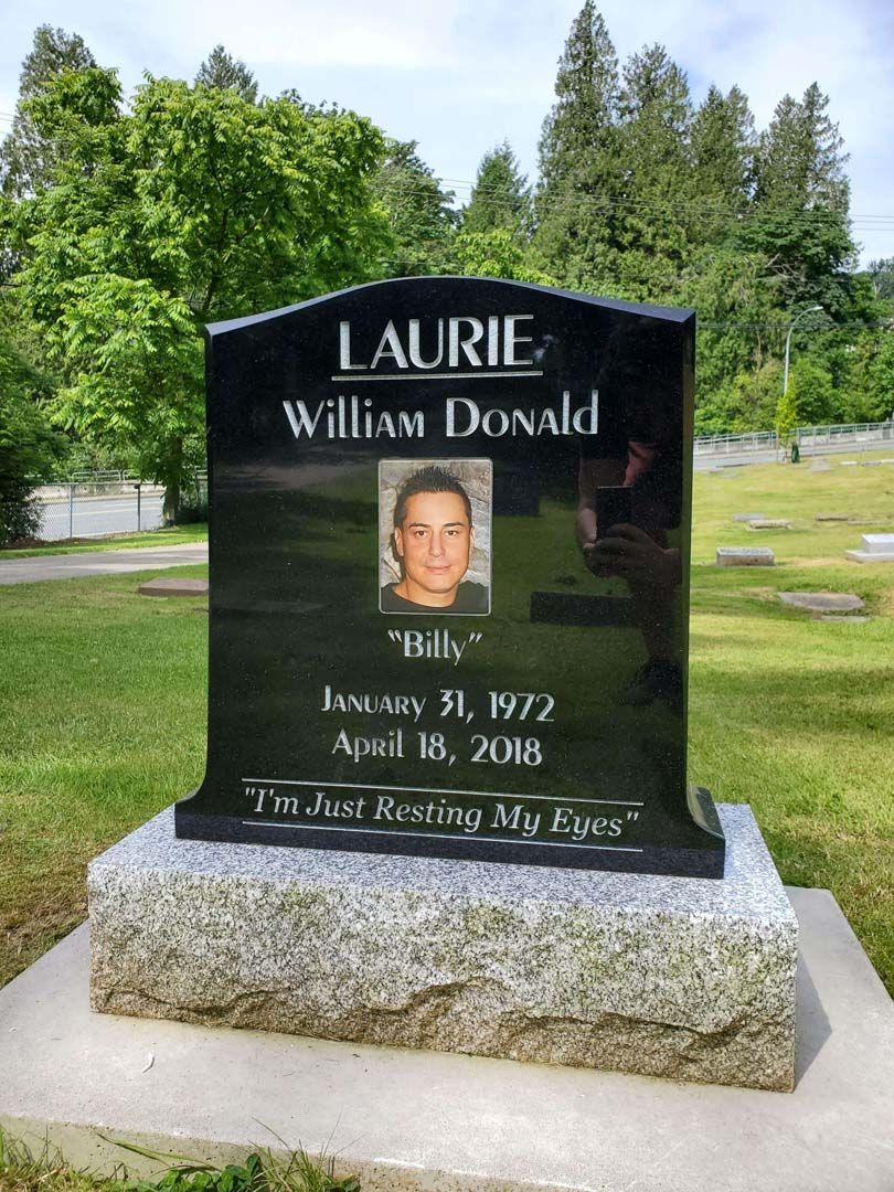 a black gravestone with the name Laurie on it