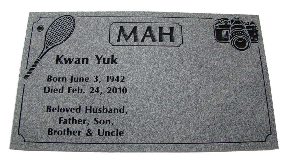 A gravestone for a man named mah with a tennis racquet on it.