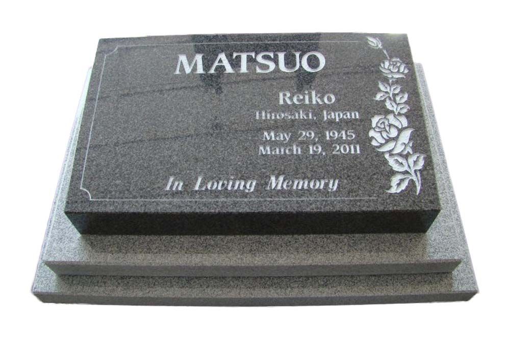A black gravestone with the name matsuo on it