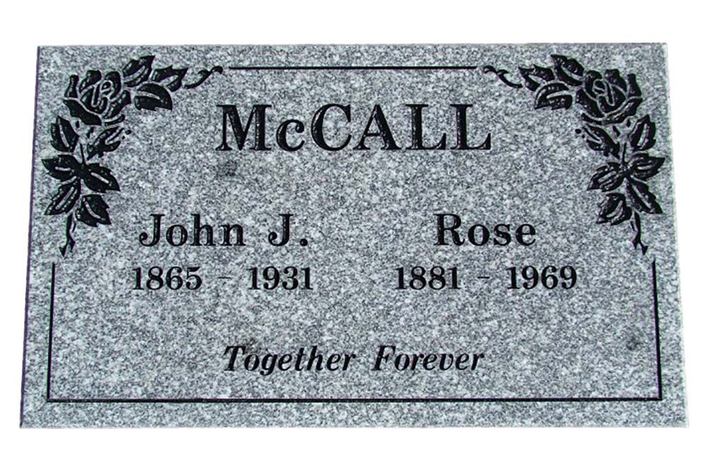 A gravestone for a man named mccall with roses on it.