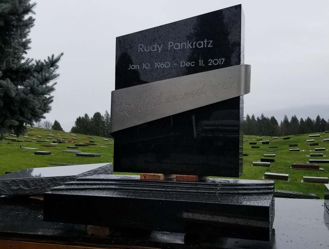 A gravestone in a cemetery with the name rudy pankratz on it