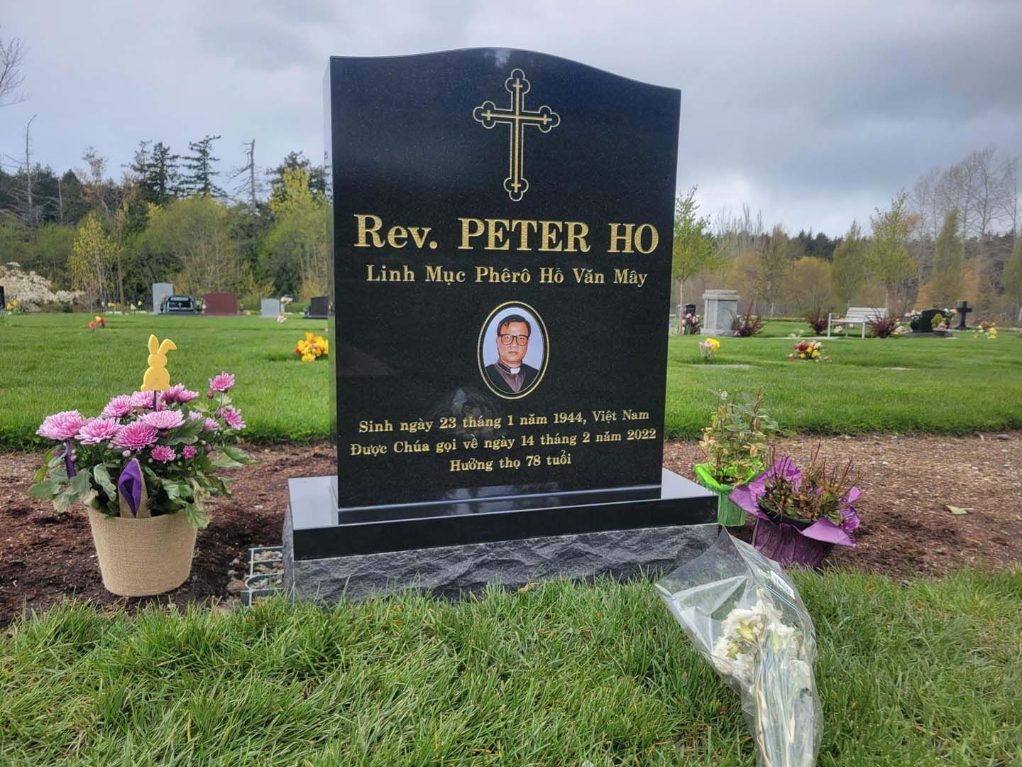 a gravestone for rev. peter ho in a cemetery