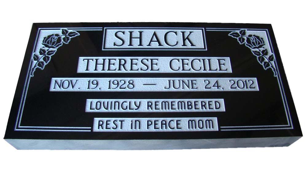 A black gravestone with the name shack on it