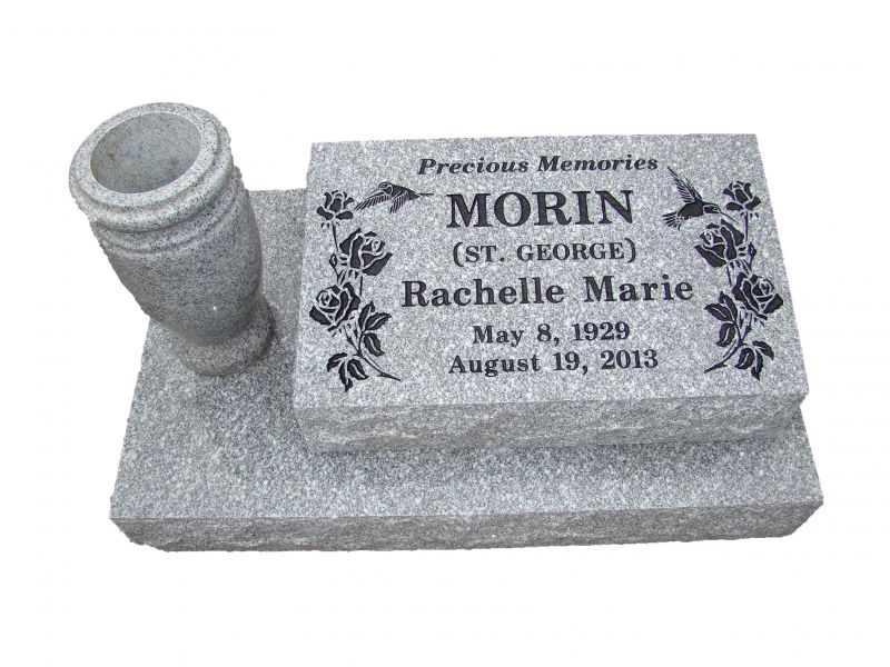 A gravestone for a woman named morin with a vase on top of it.