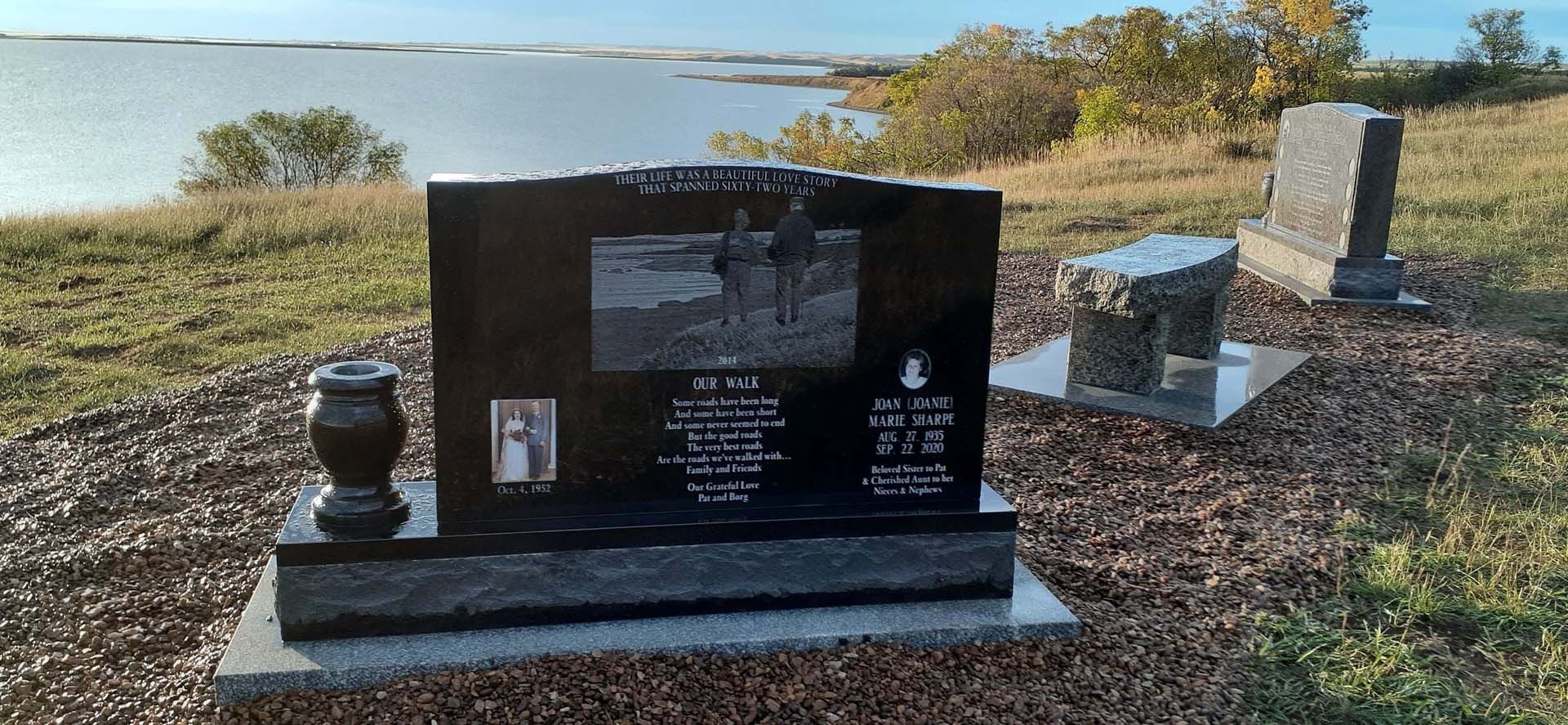 a cemetery with a large black gravestone in the middle of a field .