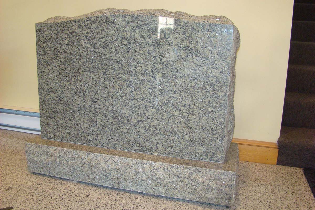 a gravestone is sitting on top of a granite counter top .
