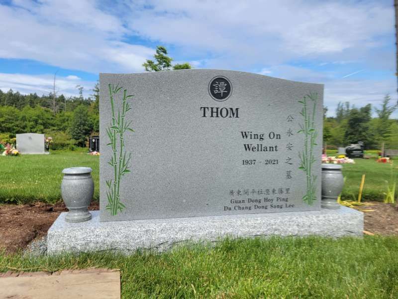 a gravestone for thom wing on wellant in a cemetery