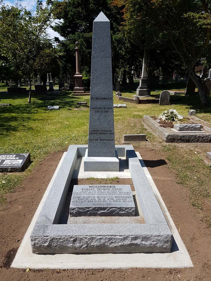 a grave in a cemetery with a large obelisk in the middle .